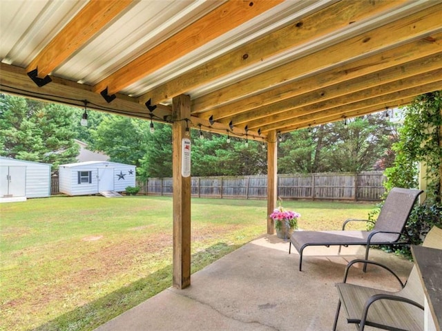 view of patio / terrace with a storage shed and an outbuilding