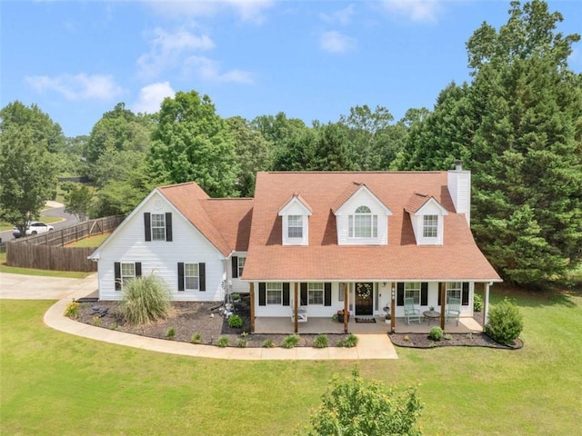 cape cod home with covered porch and a chimney
