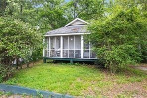 view of outdoor structure featuring a sunroom