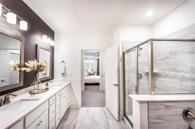 bathroom with vanity and a shower with shower door