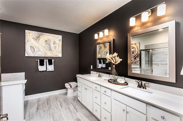 bathroom with a shower with door, vanity, and toilet