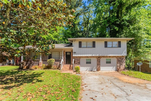 802 San Miguel Dr, Stone Mountain, GA 30083 - split level home with a porch, brick siding, driveway, and a front lawn