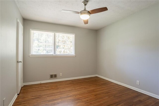 802 San Miguel Dr, Stone Mountain, GA 30083 - empty room featuring dark wood-style flooring, a ceiling fan, baseboards, and a textured ceiling