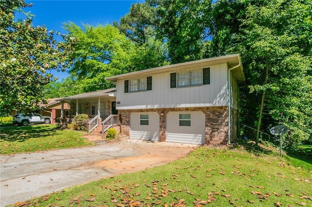 802 San Miguel Dr, Stone Mountain, GA 30083 - tri-level home with brick siding, a front yard, covered porch, and driveway