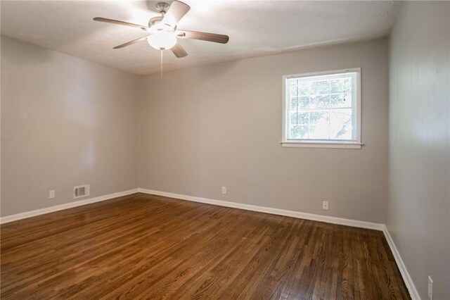 802 San Miguel Dr, Stone Mountain, GA 30083 - empty room with dark wood-style flooring, baseboards, and a ceiling fan
