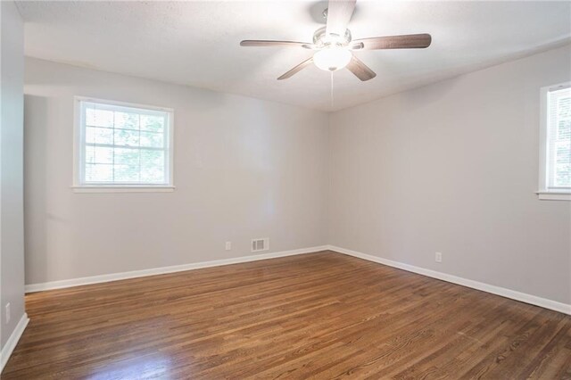 802 San Miguel Dr, Stone Mountain, GA 30083 - spare room with wood finished floors, plenty of natural light, and baseboards