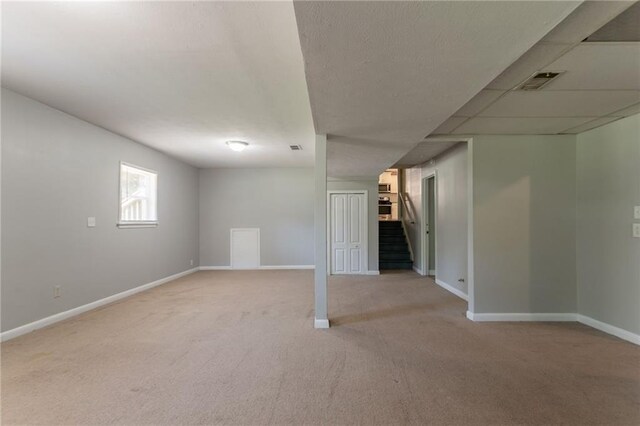 802 San Miguel Dr, Stone Mountain, GA 30083 - basement featuring light colored carpet, stairway, and baseboards