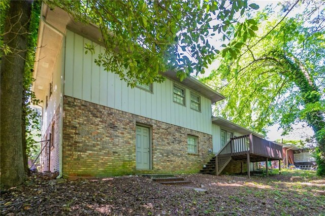 802 San Miguel Dr, Stone Mountain, GA 30083 - view of property exterior with brick siding, stairway, and a deck