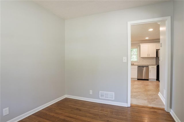 802 San Miguel Dr, Stone Mountain, GA 30083 - spare room featuring baseboards, wood finished floors, and recessed lighting