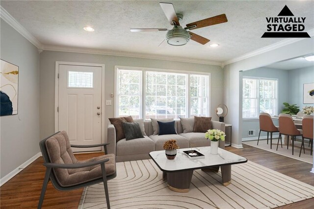 802 San Miguel Dr, Stone Mountain, GA 30083 - living room featuring plenty of natural light, dark wood-type flooring, baseboards, ornamental molding, and recessed lighting