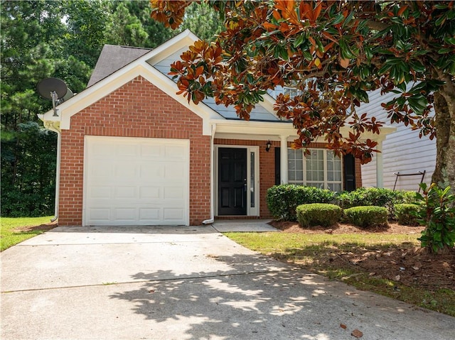 view of front of home with driveway, a garage, and brick siding