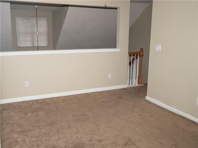 carpeted empty room with baseboards