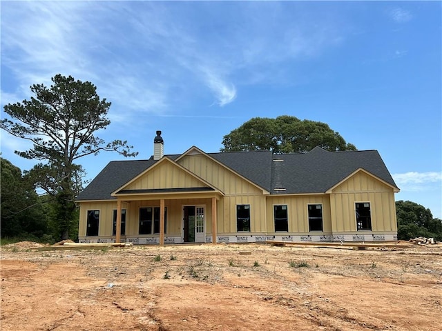 969 Lindsey Lake Dr, Dallas, GA 30132 - view of front of property featuring board and batten siding, a chimney, roof with shingles, and covered porch