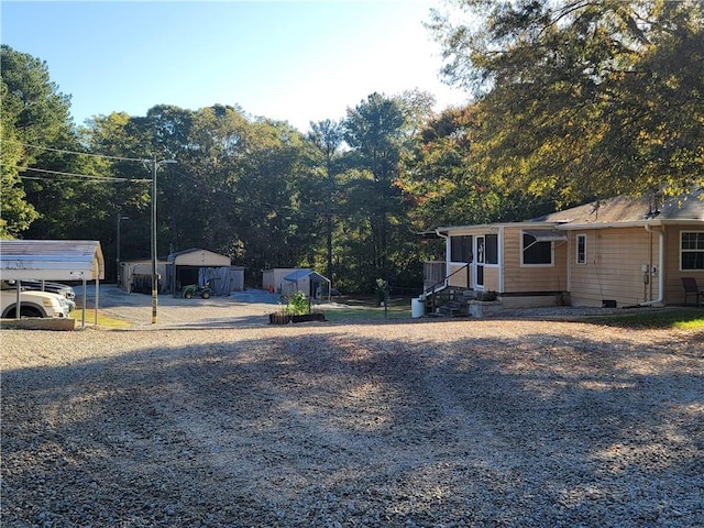 view of yard with a carport and a storage shed