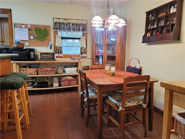 tiled dining room with a chandelier