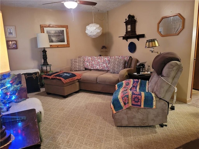 living room featuring a textured ceiling, ceiling fan, and carpet floors