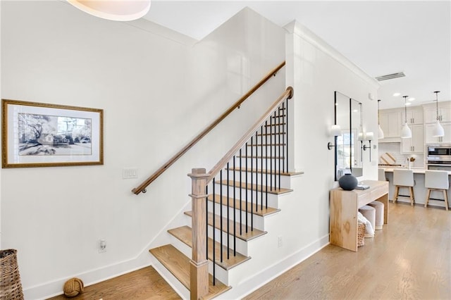 staircase with wood-type flooring