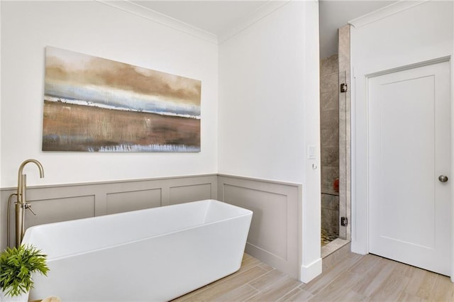 bathroom featuring hardwood / wood-style flooring, shower with separate bathtub, and ornamental molding