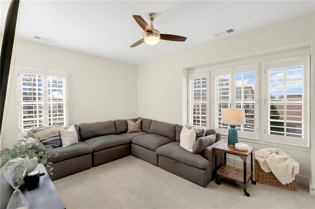 living room featuring ceiling fan and light colored carpet