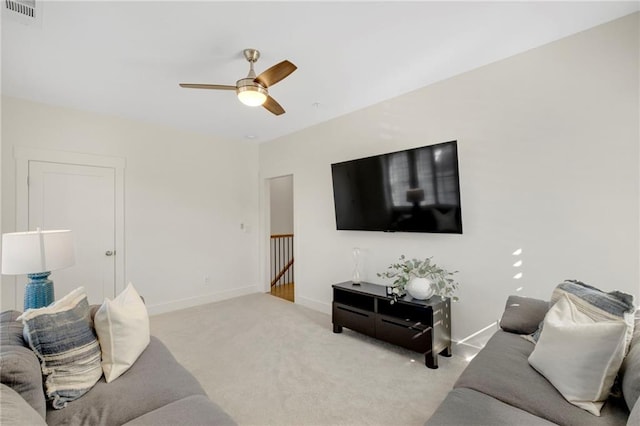 living room with light colored carpet and ceiling fan