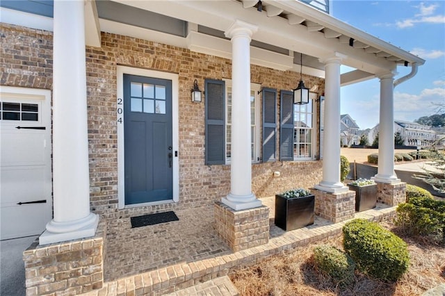 view of exterior entry with covered porch