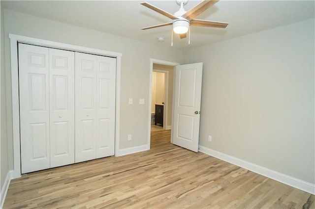 unfurnished bedroom featuring ceiling fan, a closet, and light hardwood / wood-style floors