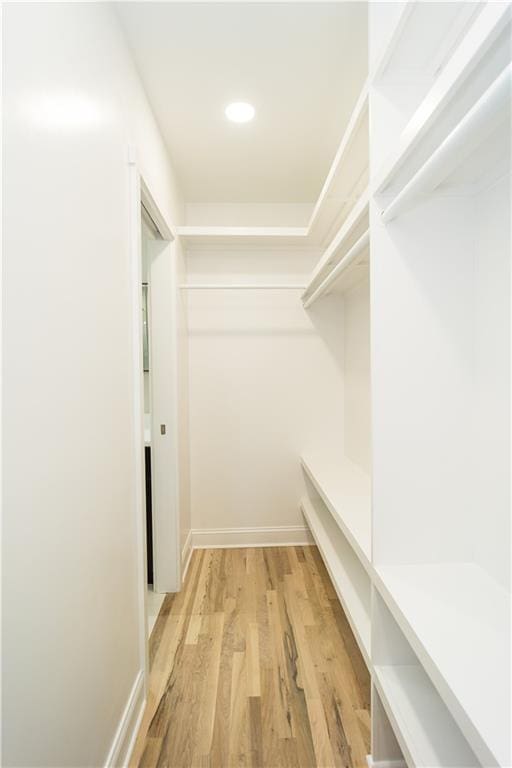 spacious closet with light hardwood / wood-style flooring