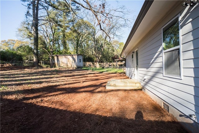 view of yard featuring a storage unit