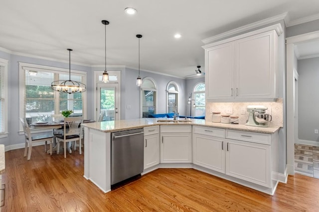 kitchen featuring dishwasher, a sink, light wood-style floors, a peninsula, and white cabinetry