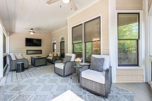 sunroom / solarium with plenty of natural light and a ceiling fan