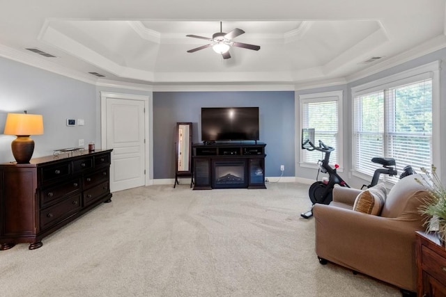 living room featuring visible vents, light carpet, a ceiling fan, and a tray ceiling