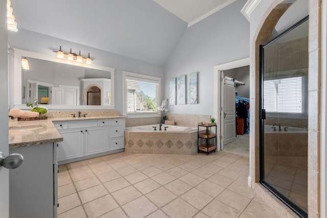 bathroom featuring a bath, vaulted ceiling, tile patterned floors, and a stall shower