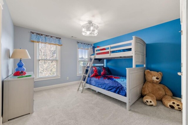 bedroom featuring carpet and baseboards