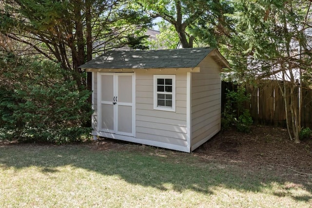 view of shed with fence