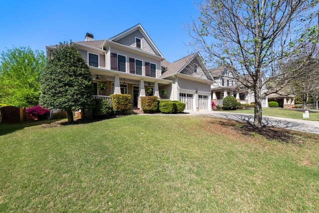 craftsman-style house featuring a garage, driveway, a front lawn, and covered porch