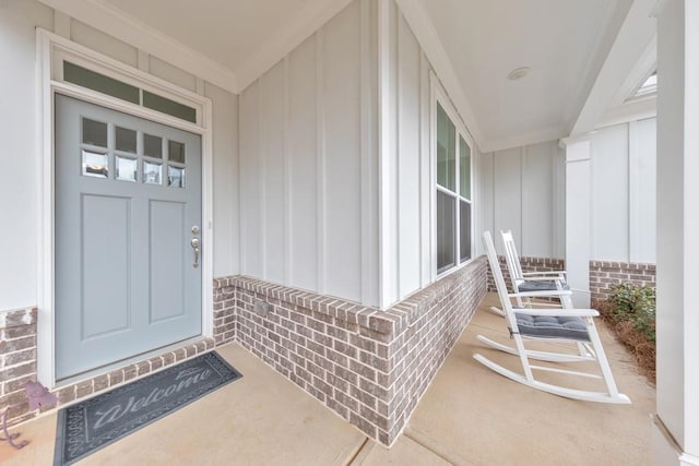 doorway to property with brick siding and board and batten siding