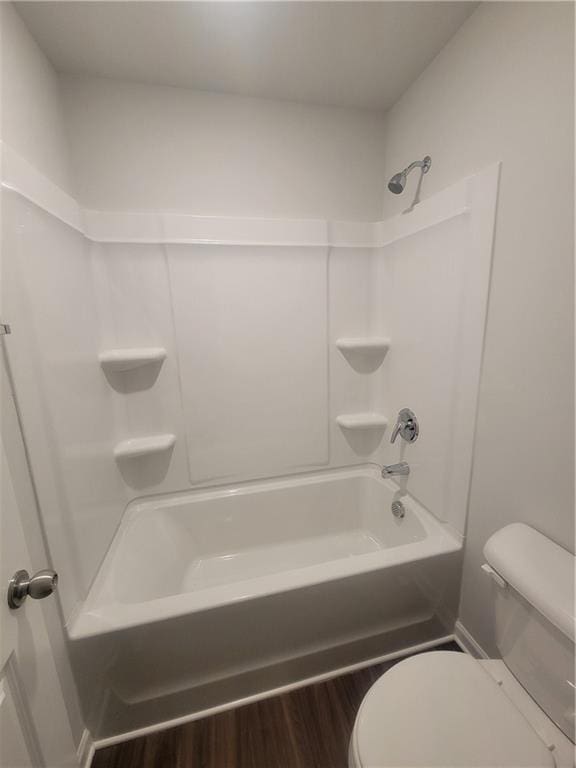 full bath featuring  shower combination, wood finished floors, and toilet