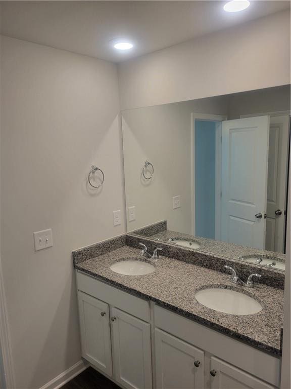 bathroom featuring double vanity and a sink
