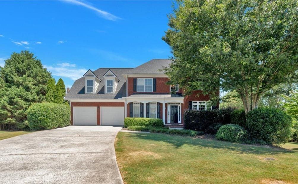 view of front of property featuring a garage and a front lawn