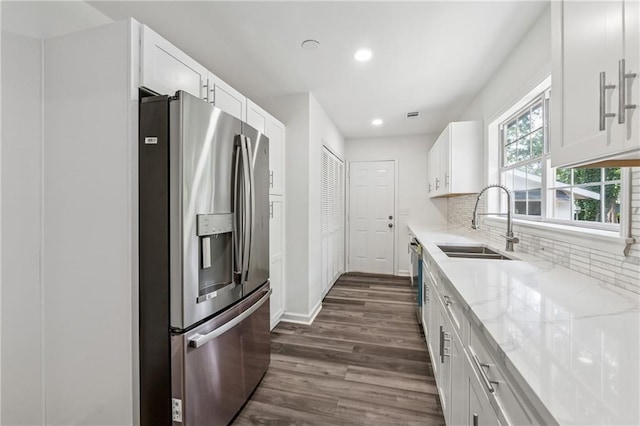 1978 Ethel Ln, Decatur, GA 30032 - kitchen with appliances with stainless steel finishes, dark wood-type flooring, recessed lighting, white cabinetry, and light stone countertops