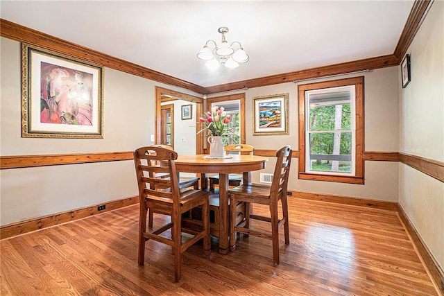 3392 Inns Brook Way, Snellville, GA 30039 - dining area featuring ornamental molding, a chandelier, light wood-style floors, and baseboards