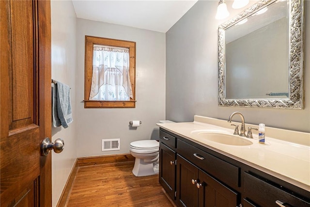 3392 Inns Brook Way, Snellville, GA 30039 - bathroom featuring wood finished floors, baseboards, toilet, and vanity
