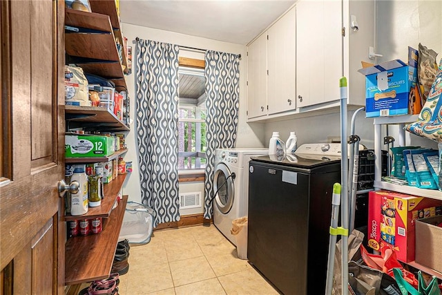 3392 Inns Brook Way, Snellville, GA 30039 - laundry area featuring washing machine and dryer, cabinet space, and light tile patterned floors