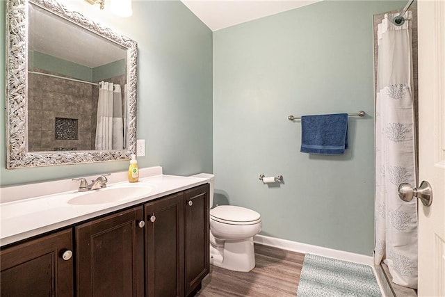 3392 Inns Brook Way, Snellville, GA 30039 - bathroom with wood finished floors, toilet, vanity, baseboards, and a shower with shower curtain