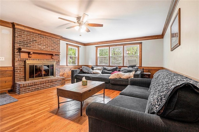 3392 Inns Brook Way, Snellville, GA 30039 - living area with a wainscoted wall, crown molding, wooden walls, a ceiling fan, and light wood-style floors