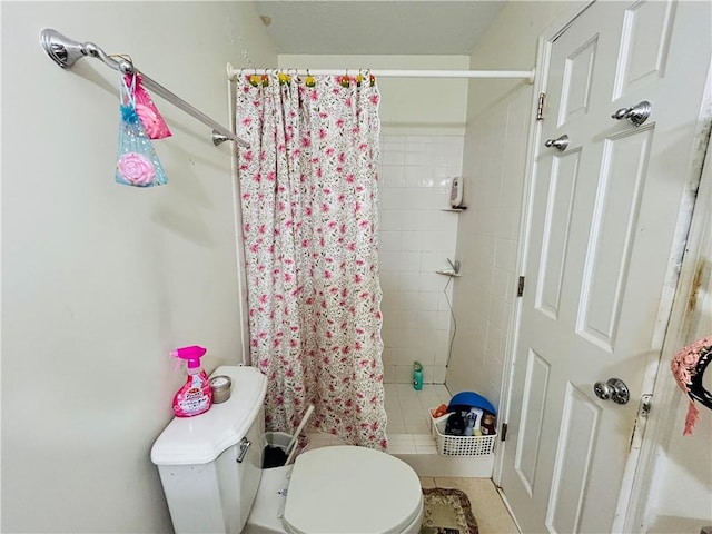 full bathroom with a shower stall and toilet