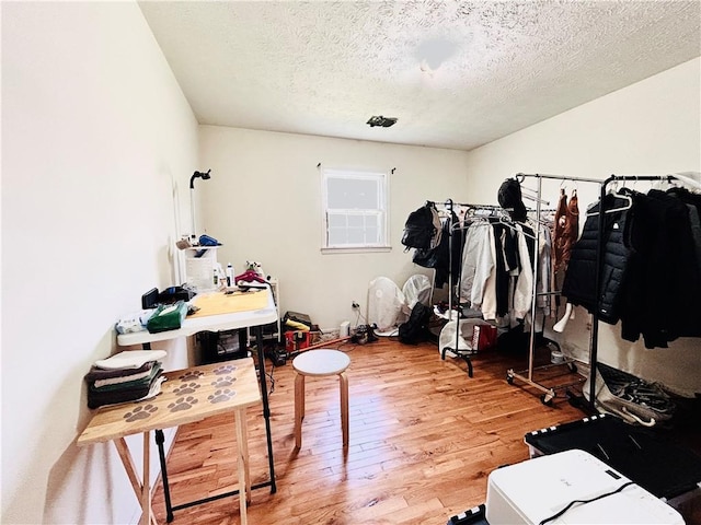 walk in closet with wood finished floors