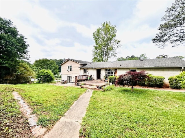 back of property featuring a wooden deck and a lawn