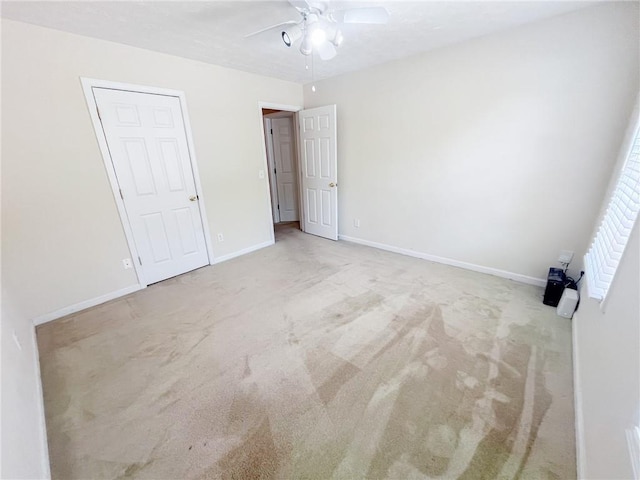 unfurnished bedroom featuring baseboards, a ceiling fan, and carpet floors