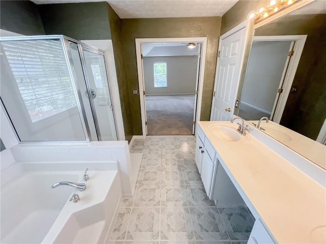 bathroom featuring vanity, baseboards, a shower stall, and a garden tub